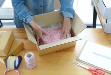 Online sellers are packing products into boxes for shipping to customers.