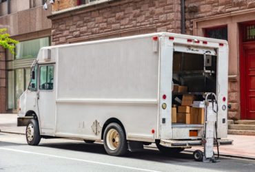 White color truck delivering packages, Manhattan downtown
